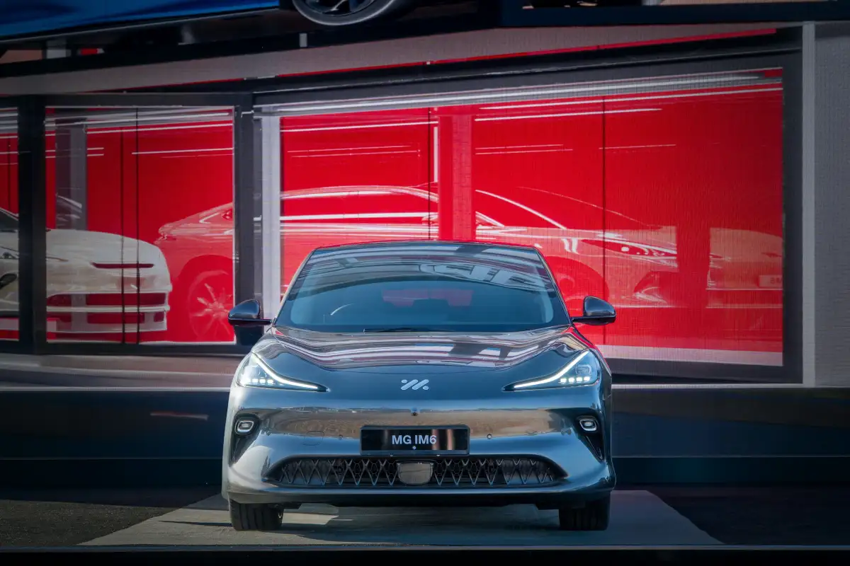 A sleek car is parked in front of a showroom.